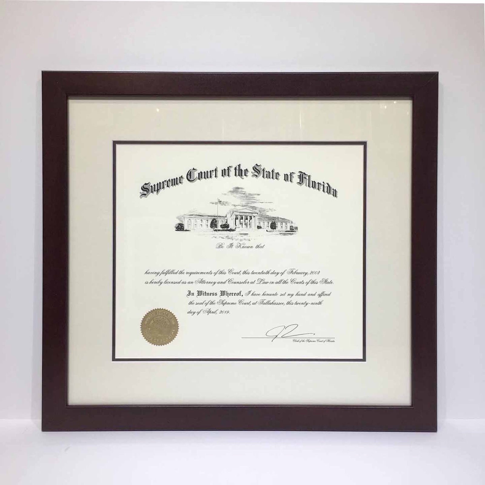 Florida Supreme Court license in dark wood with double mat.