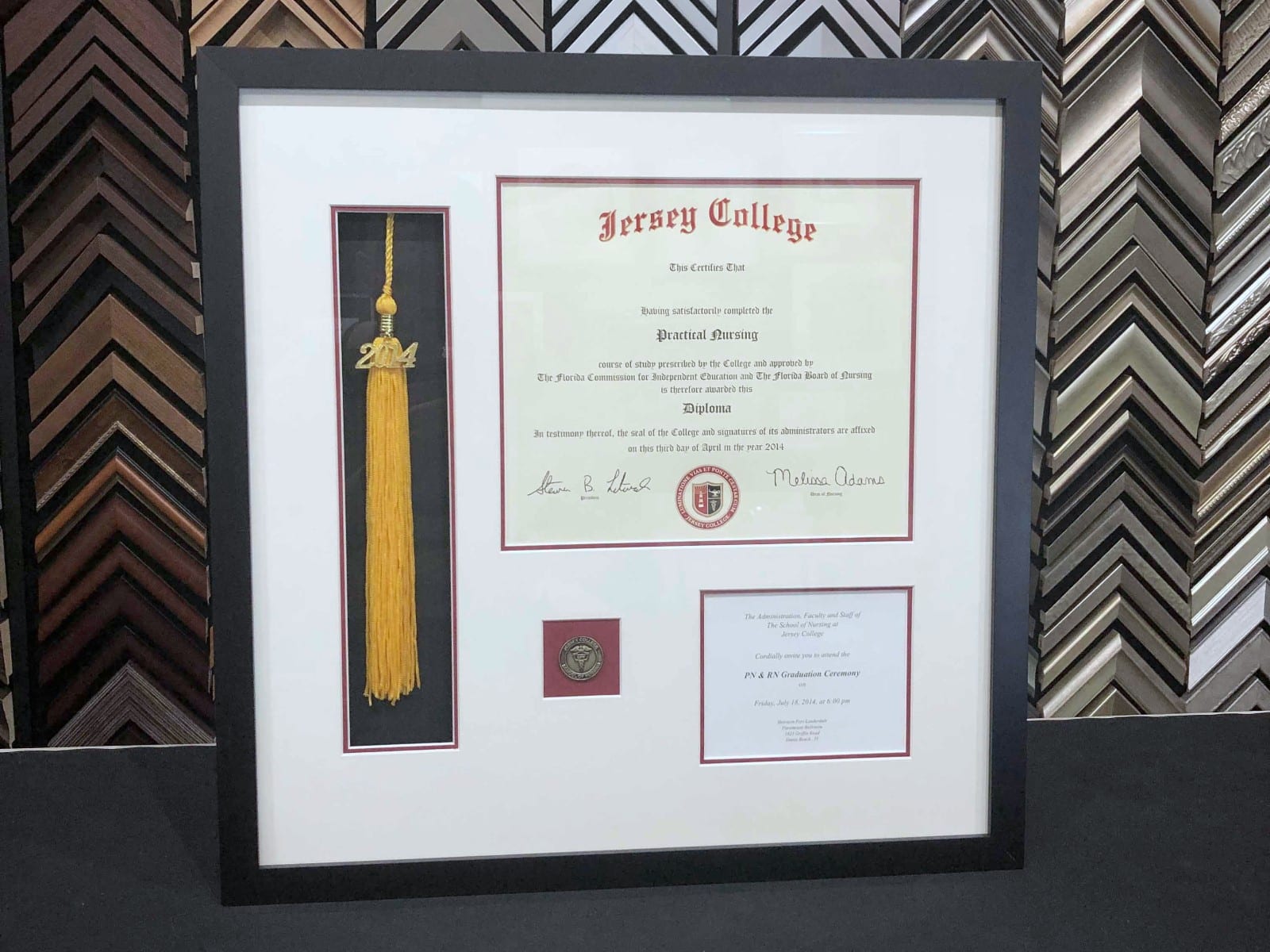 A diploma framed with its gold tassel.