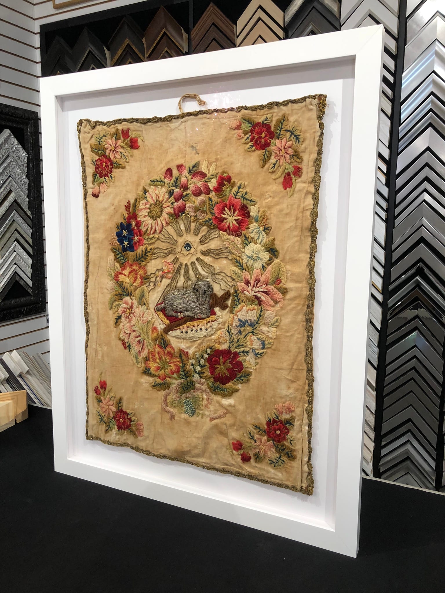 An 1854 embroidered textile in a shadowbox.