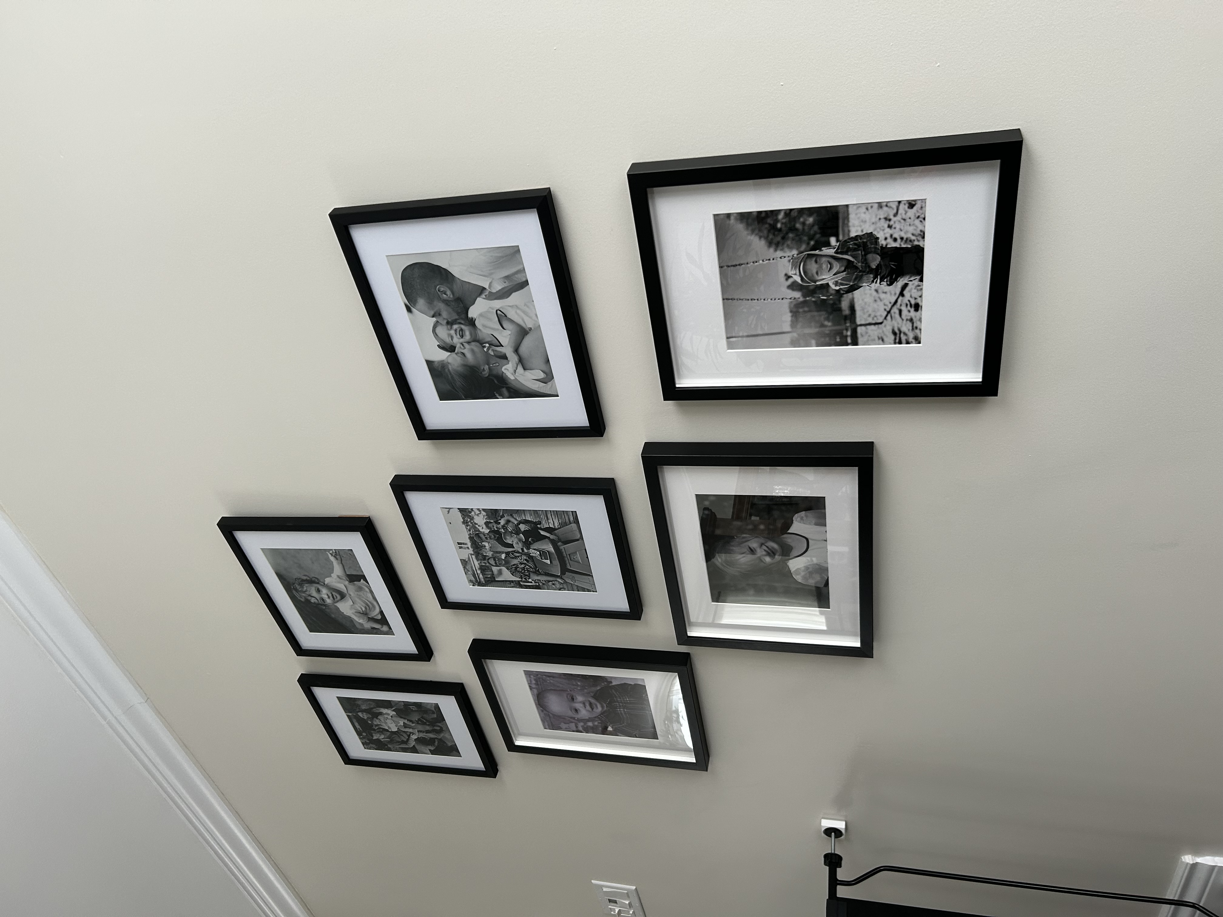 Black-and-white family photo gallery wall.