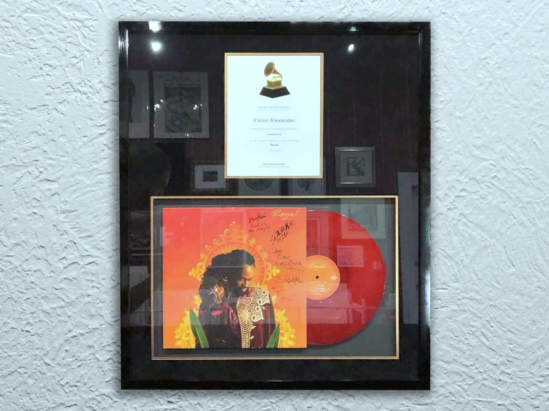 A Grammy nomination framed with a signed vinyl record.