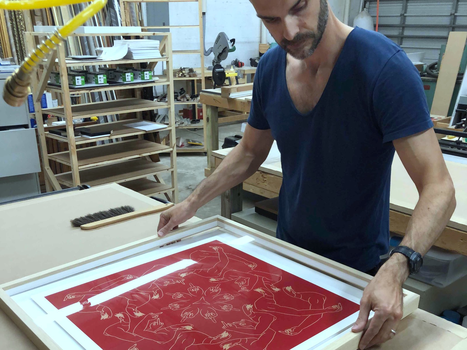Framer setting spacers in a deep wood frame.